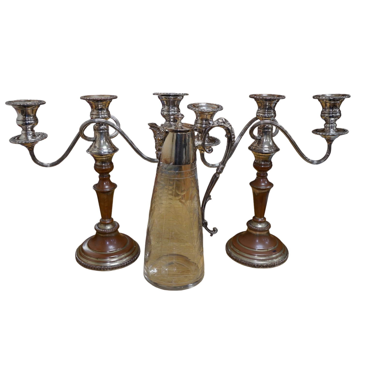 A Victorian silver plated claret jug, together with a pair of candelabra, 30cm. Condition - worn